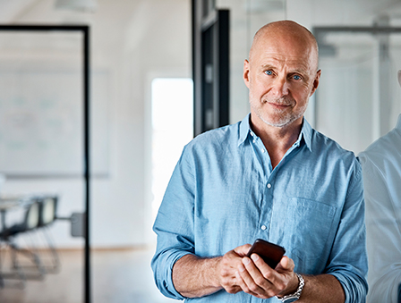 Man leaning against a wall with cell phone