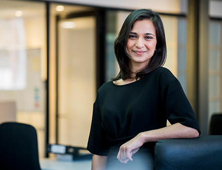 Woman in her late 30's with dark hair in office setting