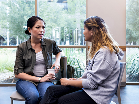 Two women sitting together having a conversation