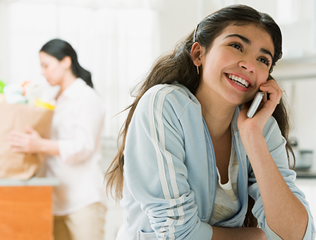 smiling teen talking on cell phone